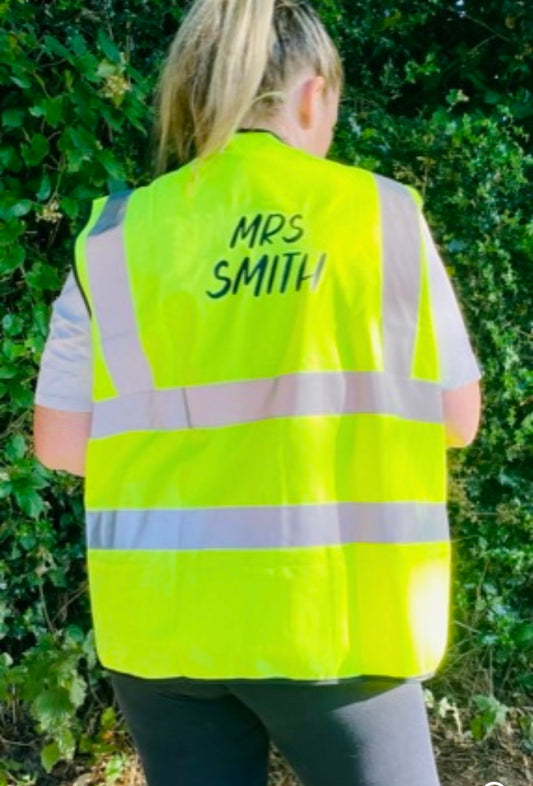 Back of personalised yellow high-vis vest with Mrs Smith text